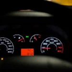 Driver in an SUV looking at an AWD warning light on the dashboard