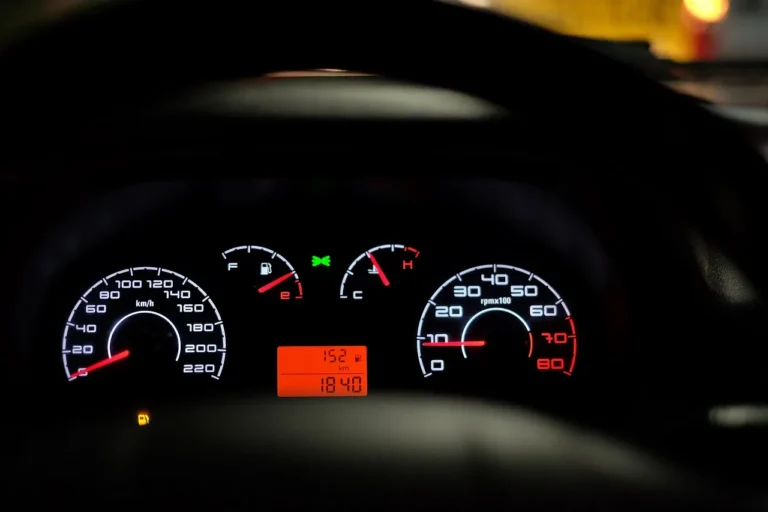 Driver in an SUV looking at an AWD warning light on the dashboard