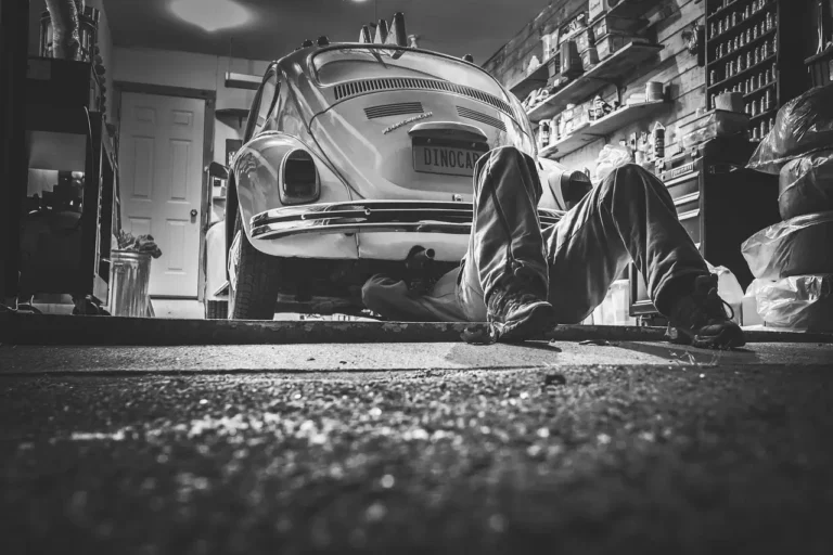 Mechanic reviewing a transmission replacement estimate at an auto repair counter