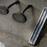 Mechanic inspecting a clutch pedal stuck on the floor in a car footwell